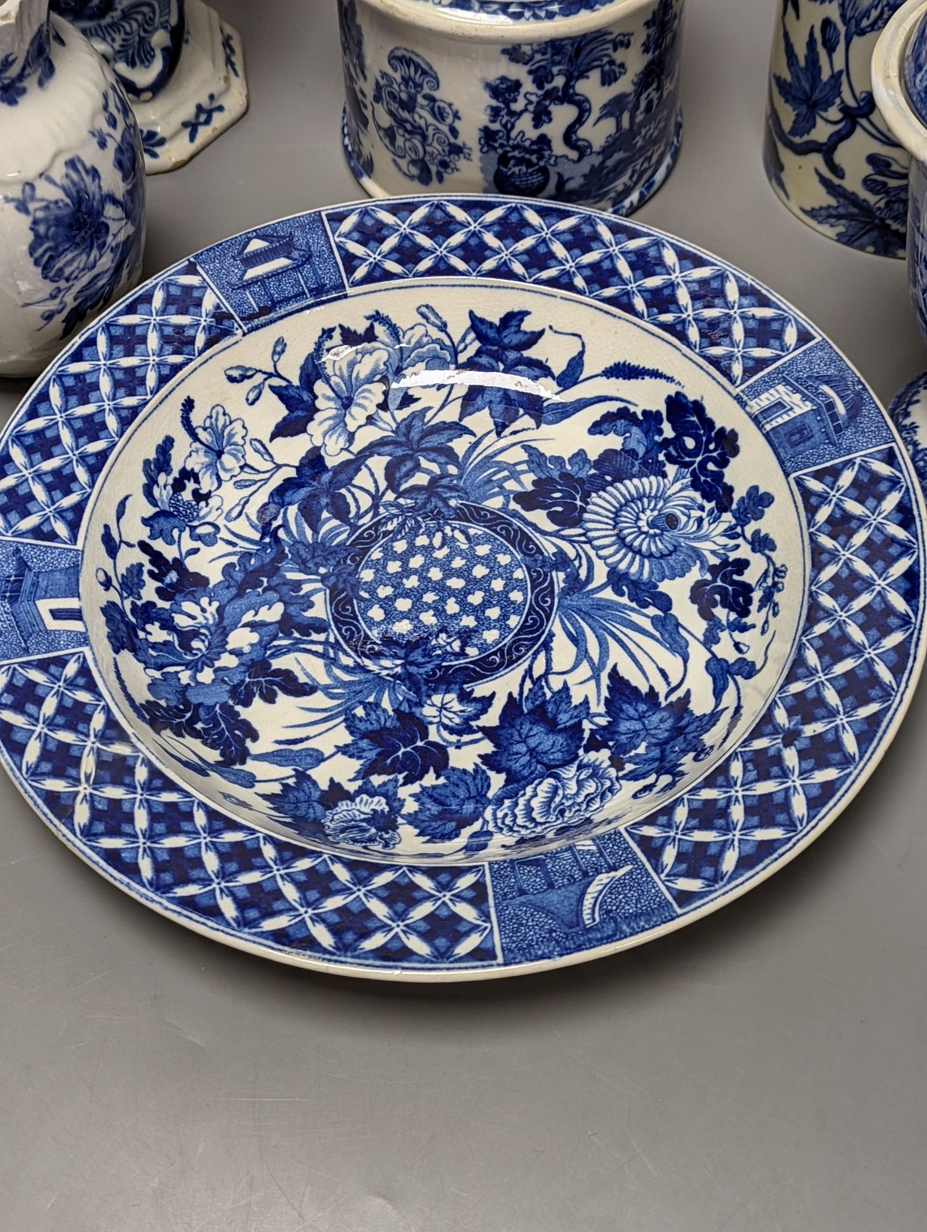 Four items of early 19th century blue and white pearlware pottery, an 18th century Delft blue and white vase and a 19th century toothbrush holder, Delft vase 22 cms high.